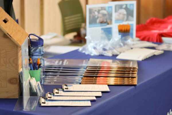 pamphlets sit on a table with a blue tablecloth