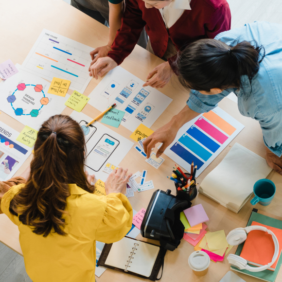 Group of creatives collaborating over notes