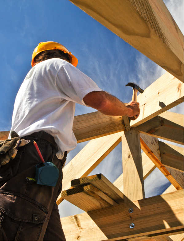 Trades student hammering a structure