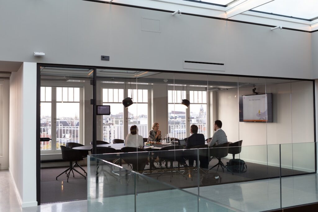 View from hallway of small group in a boardroom