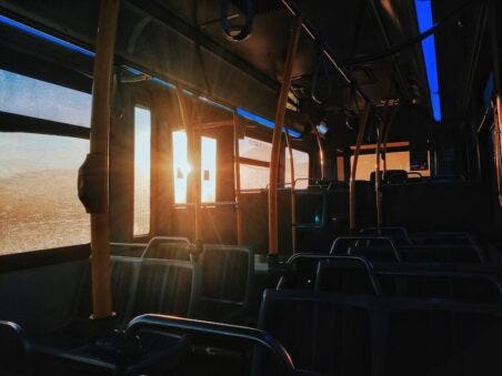 Interior of bus with sun flair coming through rear doors