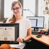 Wellstead holding framed PhD