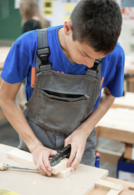 Trades student working with wood clamp