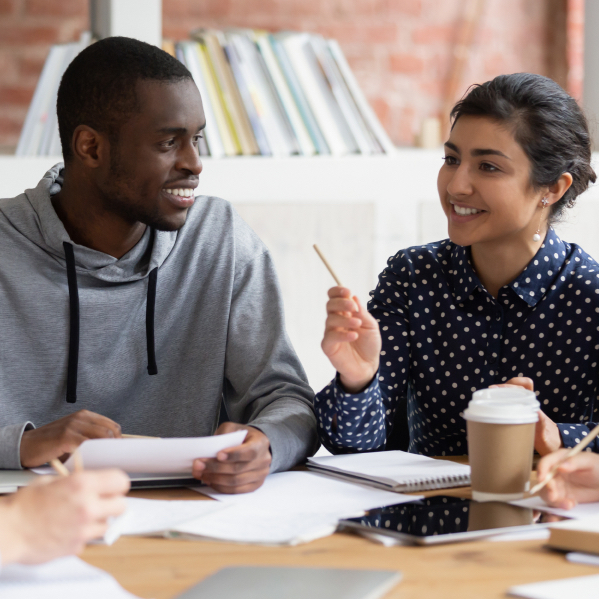 Two students in study group talking and smiling