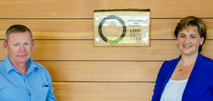 Regional facilities manager Murray Armstrong 
and NLC President Laurie Rancourt with the 
LEED Platinum plaque on the wall of Energy
House.