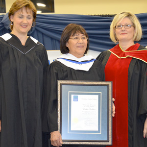 Catherine Dokkie receives her
Honorary Associate of Arts Degree from
NLC President Laurie Rancourt and
Registrar Dr. Loren Lovegreen.