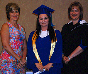 Alicia Remenda-Alton, the 2013 Class Valedictorian, received her credential
from NLC Board Chair Karen Simpson and NLC President Laurie Rancourt.