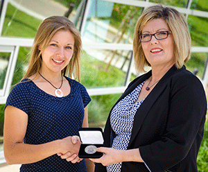 Katherine Finke received the Lieutenant Governor’s Silver Medal from NLC Registrar Dr. Loren Lovegreen. 

