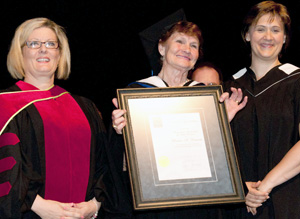 Mavis Brown is presented with her Honorary Associate of Arts Degree by NLC Registrar
Dr. Loren Lovegreen and President Laurie Rancourt.