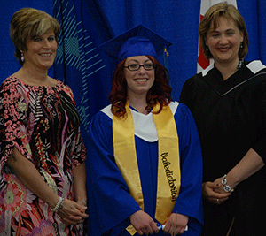 Dana Hall, the 2013 Valedictorian, received her Applied Business Technology credential from Board Chair Karen Simpson and President Laurie Rancourt.