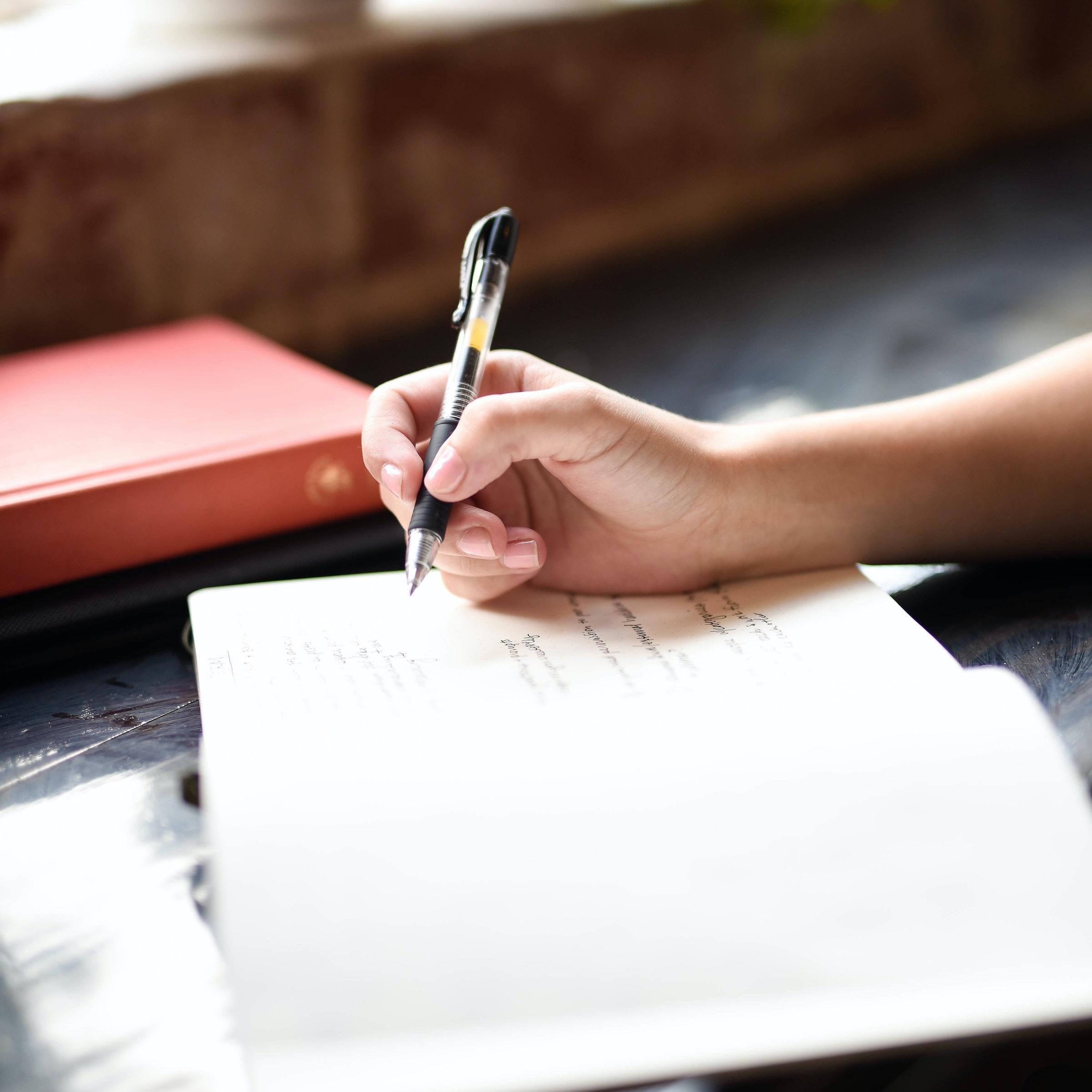 Closeup of hand writing in notebook